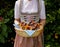 woman wearing Bavarian dirndl dress holding basket of pretzels at Bavarian Oktoberfest (Munich, Bavaria, Germany)