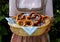 woman wearing Bavarian dirndl dress holding basket of pretzels at Bavarian Oktoberfest (Munich, Bavaria, Germany)