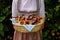 woman wearing Bavarian dirndl dress holding basket of pretzels at Bavarian Oktoberfest (Munich, Bavaria, Germany)