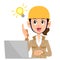 A woman wearing a beige clothes in the construction industry  who operates a computer with an idea flashing