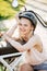 Woman wearing biking helmet. Close-up portrait of female cyclist in park.