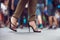 Woman wearing black high heels summer shoes walking in the city crowd. Woman feet making step on city street.