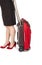 Woman Wearing Black Pencil Skirt and Pumps Pulling a Small Travel Luggage #1