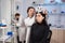 Woman wearing brain wave headset in modern medicine lab with neurologist doctor health physician