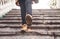 Woman wearing brown leather boots. Walking down the stairs