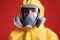 Woman wearing chemical protective suit on background, closeup. Virus research