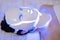 Woman is wearing cosmetic face photon mask. Health and beauty. Cosmetic procedure for woman face. Beauty laboratory. LED Facial