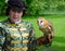 Woman wearing Elizabethan costume with Barn Owl on Gloved hand.