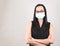 Woman wearing eyeglasses and  hygienic mask ,standing and crossing her arms ,daily protection from corona virus or COVID-19