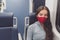 Woman wearing face mask in public transportation during coronavirus pandemic. Face mask wearing on train transport