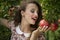 Woman wearing floral long dress against pomegranate trees