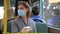 Woman wearing gloves observes safety precautions and puts on medical mask to protect against virus and infection while