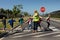 Woman wearing a high visibility vest and holding a stop sign