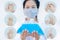 Woman wearing hygienic protective mask holding alcohol sanitizer gel standing on white background with copy space ,daily