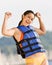 Woman wearing life jacket at beach