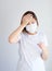 Woman wearing mask get sick from corona virus,, flu symptom as sneezing, cough, fever, body ache, breathing , pain