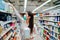 Woman wearing mask and gloves buying baby formula due to Covid-19 or Coronavirus and panic buying.Preparation for a pandemic