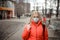 Woman wearing a mask on the street. Protection against virus and grip