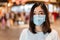 Woman wearing medical mask at shopping mall for prevention from coronavirus Covid-19 pandemic. new normal concepts