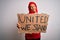 Woman wearing muslim hijab asking for union holding banner with united stand message serious face thinking about question, very