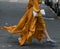 Woman wearing orange dress and purple open toe shoes