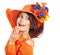 Woman wearing orange hat with flower.