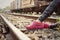 Woman wearing pink shoes at train station.