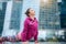 Woman wearing pink sportswear in upward facing dog pose