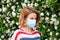 Woman wearing protect mask from pollen allergy