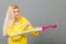 Woman wearing raincoat closing umbrella