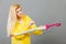 Woman wearing raincoat closing umbrella