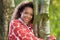 Woman Wearing Raincoat Walking In Woods