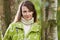 Woman Wearing Raincoat Walking In Woods