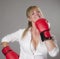 Woman wearing red boxing gloves