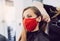 Woman wearing red face mask getting fresh styling at a hairdresser