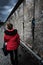 Woman wearing red jacket visits remains of Berlin Wall