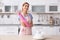 Woman wearing rubber gloves near table