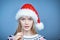 Woman wearing Santa hat holding martini glass with a straw