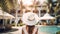 Woman wearing straw beach hat standing inside a luxurious exotic tropical resort