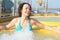 Woman wearing swimming suit is relaxing in hot tub