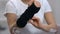 Woman wearing titan wrist brace, orthopedic support after trauma, treatment