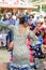 Woman wearing traditional Sevillana dresses and dancing a Sevillana at the Seville April Fair