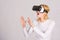 Woman wearing virtual reality goggles. Person with virtual reality helmet isolated on grey background. Woman with