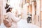 Woman wearing vr headset in european city street, virtual travel concept. Virtual reality to travel the world idea