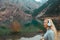 Woman wearing wireless headphones at the lake