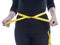 Woman wears black body clothes with yellow measuring tape, healt