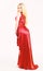 Woman wears elegant evening red dress, white background. Luxury outfit concept. Lady wears fashionable dress for