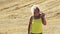 Woman wears glasses and looking into the camera, farmer on the field