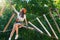 Woman wears protective helmet enjoy active leisure in rope park