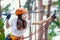 Woman wears protective helmet enjoy active leisure in rope park